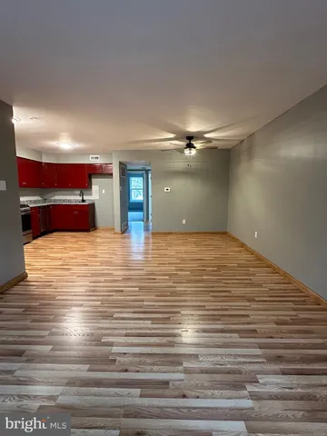 a view of a room with wooden floor