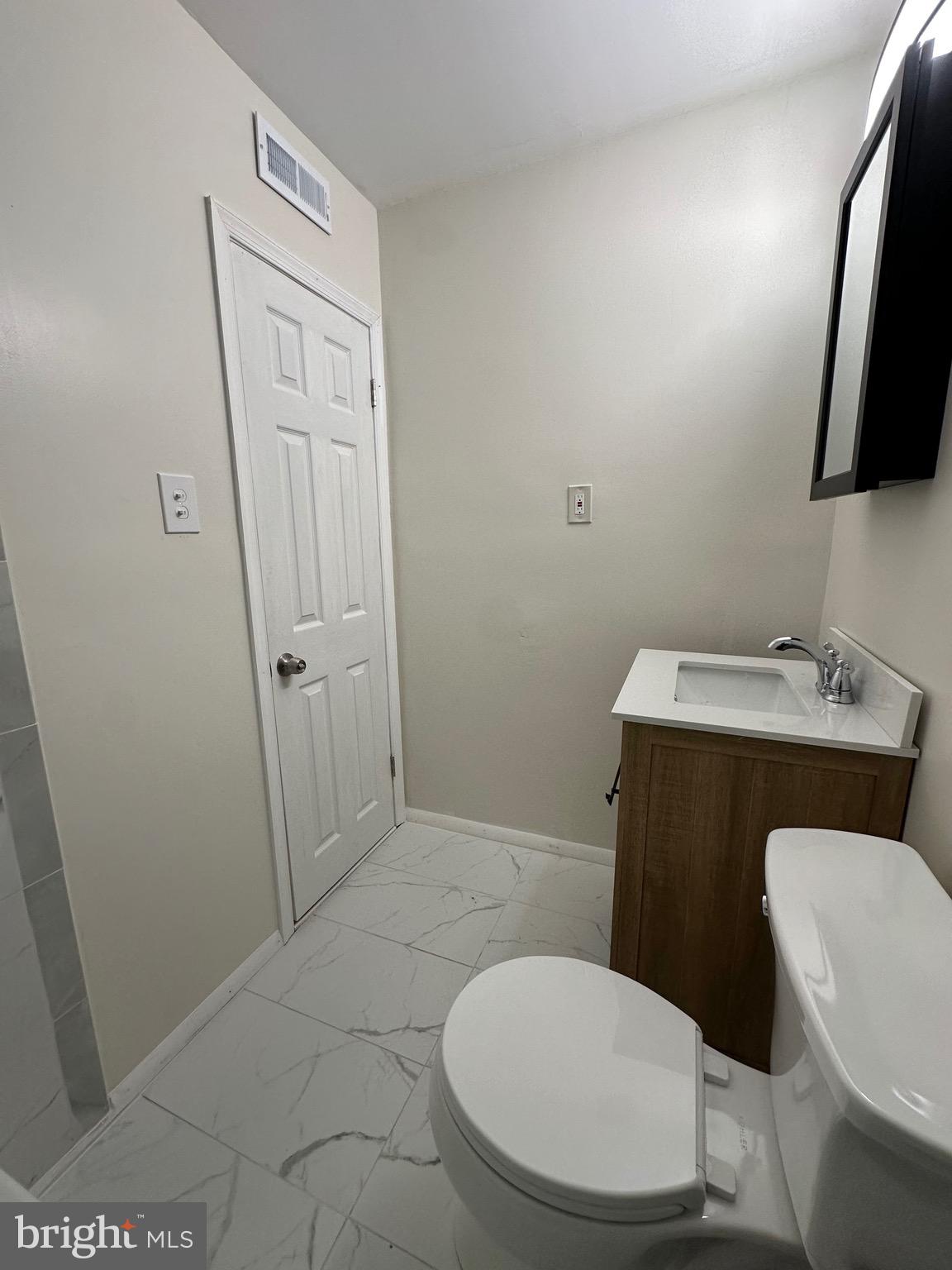 12077 Abby Road Philadelphia, PA 19154 - Photo 20 of 27 a white toilet sitting next to a bathroom sink