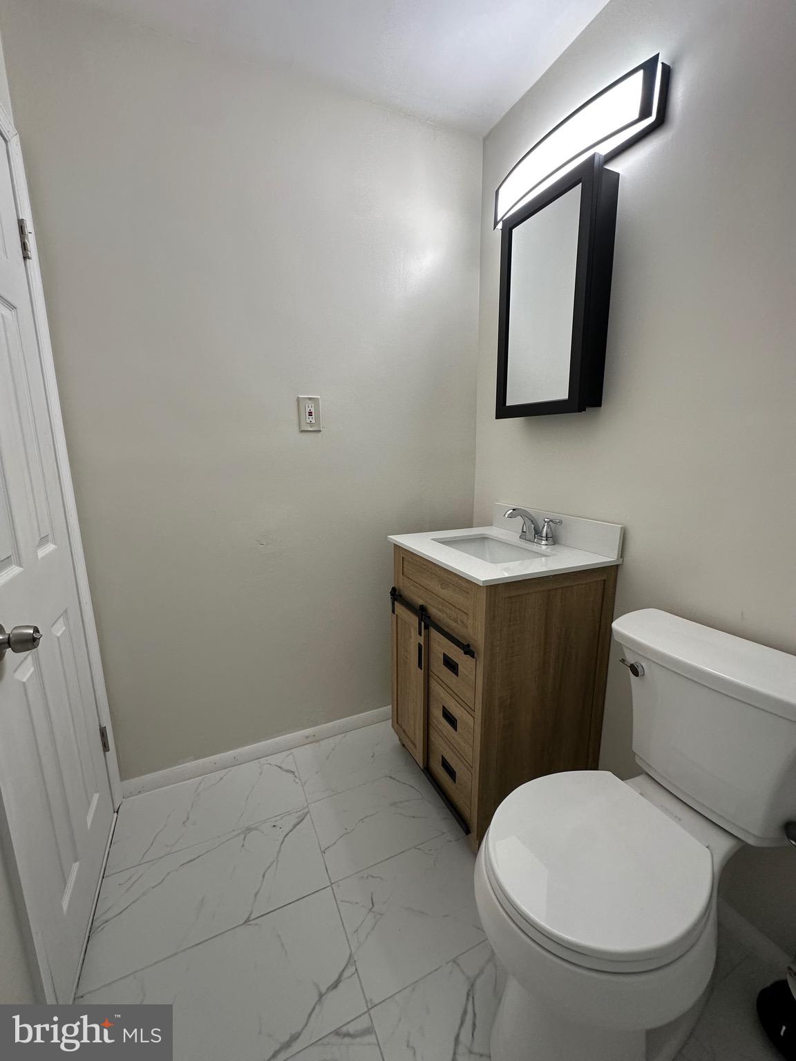 12077 Abby Road Philadelphia, PA 19154 - Photo 21 of 27 a bathroom with a toilet sink and mirror