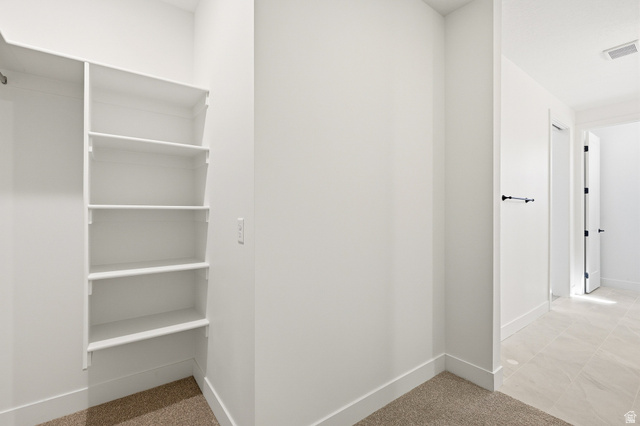 4978 North 75 East Enoch, UT 84721 - Photo 24 of 60 Walk in closet featuring light carpet