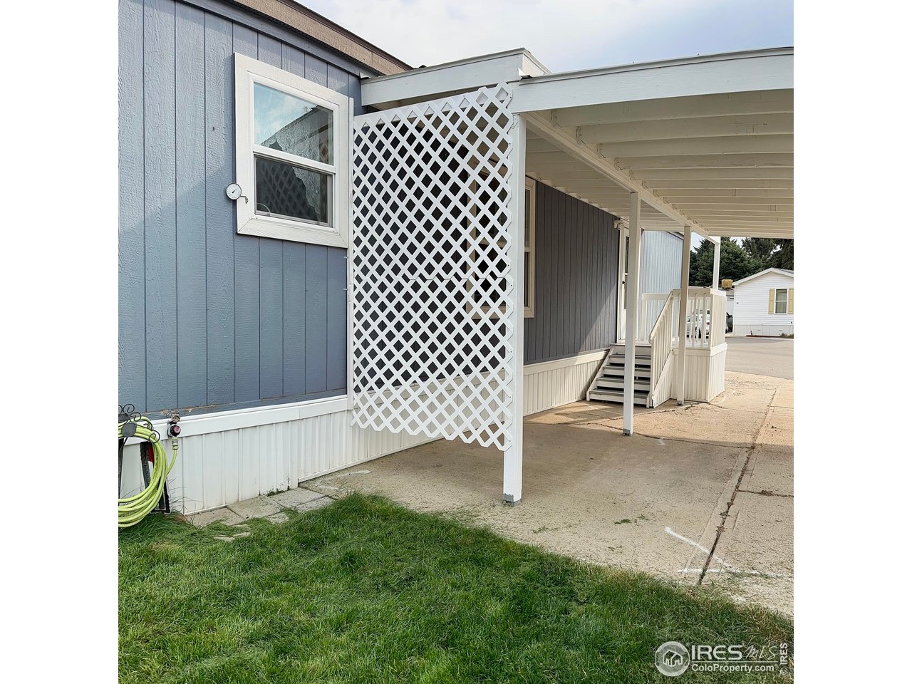 230 North 2nd Street, Unit 83 Berthoud, CO 80513 - Photo 9 of 50 Side with carport