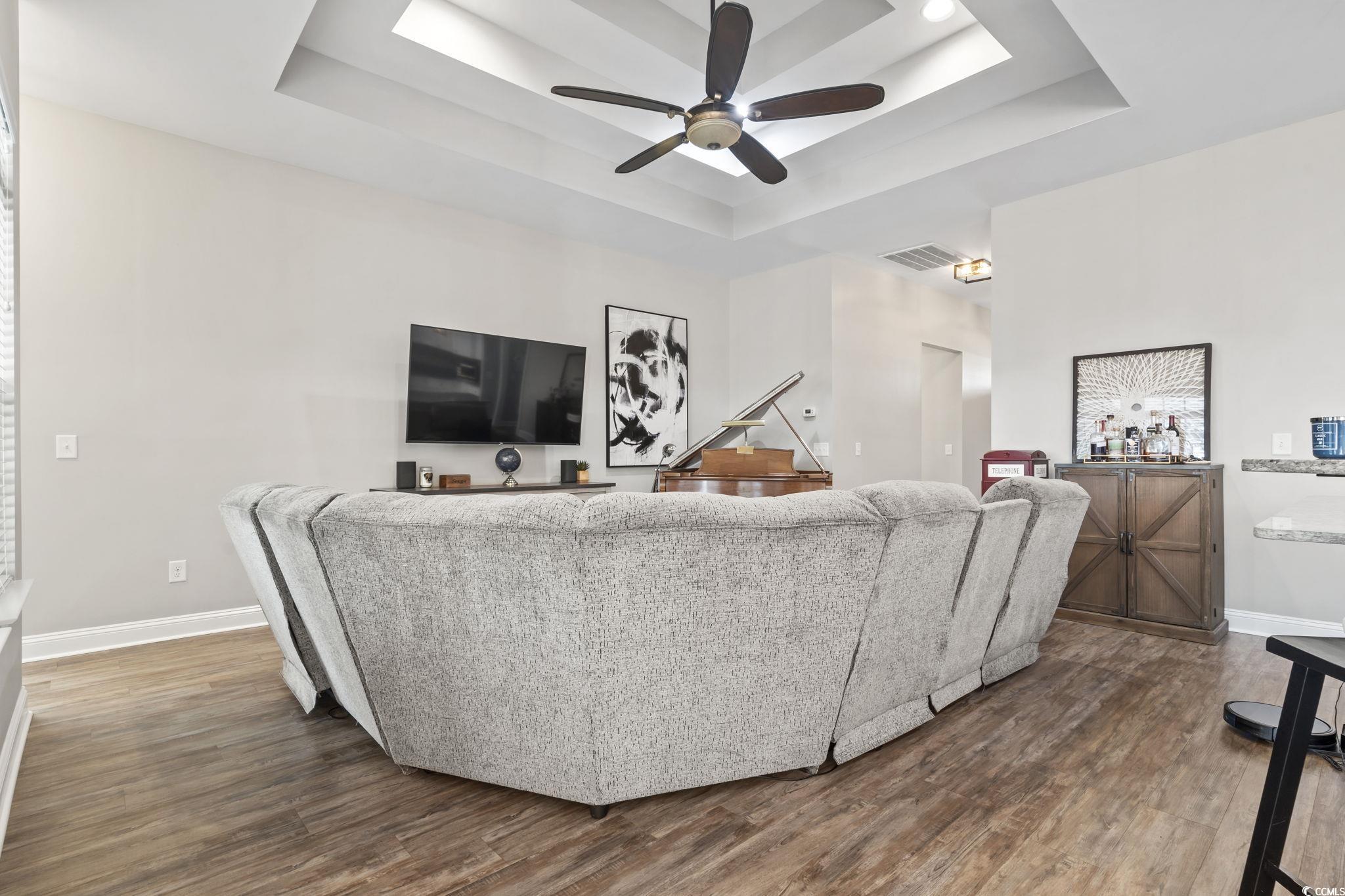 308 Turning Pines Loop Myrtle Beach, SC 29579 - Photo 14 of 33 Living room featuring ceiling fan, a tray ceiling,