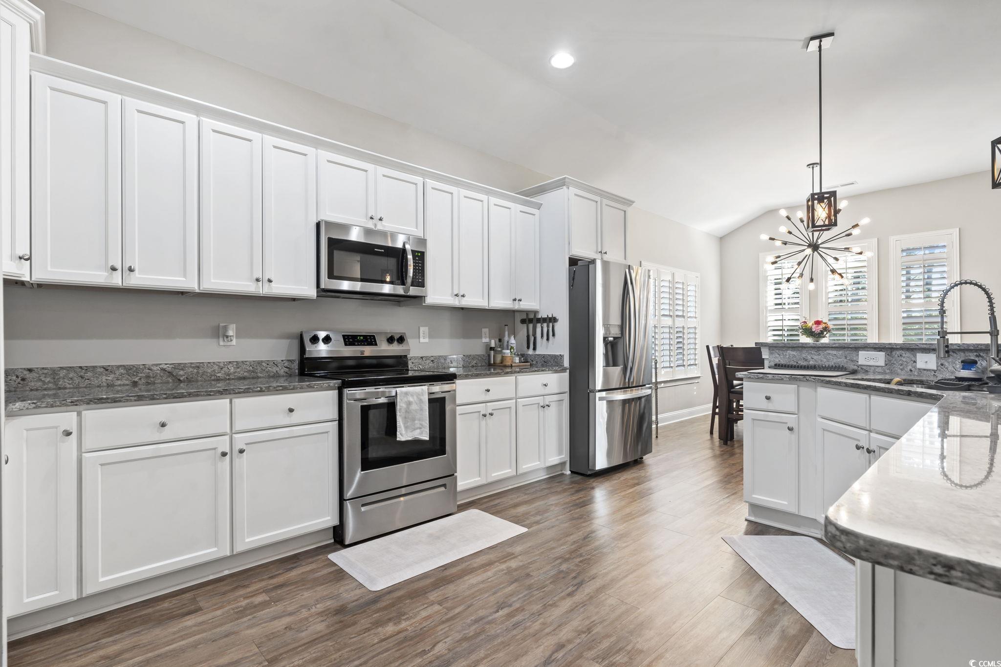 308 Turning Pines Loop Myrtle Beach, SC 29579 - Photo 9 of 33 Kitchen featuring lofted ceiling, sink, white cabi