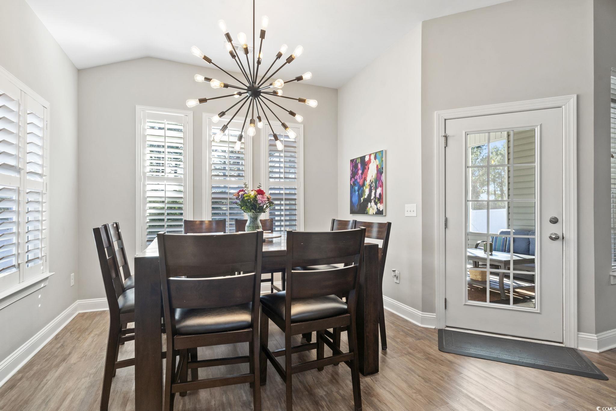 308 Turning Pines Loop Myrtle Beach, SC 29579 - Photo 10 of 33 Dining room featuring lofted ceiling, wood-type fl
