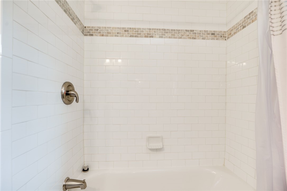 6950 Red Lion 5 Points Road Springboro, OH 45066 - Photo 39 of 78 This clean and bright bathroom features white subway tile, offering a classic aesthetic.