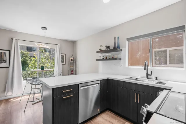 a kitchen with a sink stove and cabinets