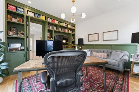 a living room with furniture fireplace and a rug