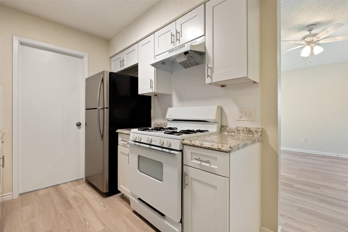 608 Country Aire Drive, Unit A Round Rock, TX 78664 - Photo 16 of 32 a kitchen with stainless steel appliances a stove a refrigerator and cabinets