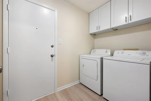 a view of storage and utility room with washer and dryer