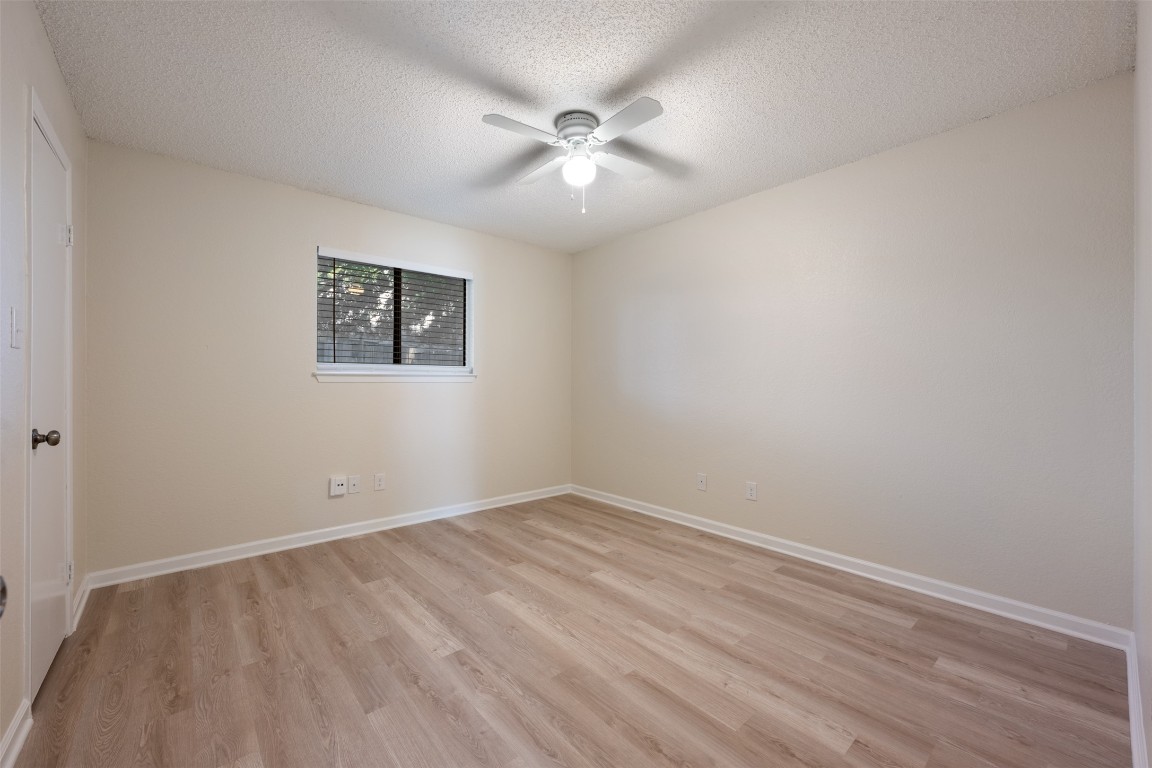 608 Country Aire Drive, Unit A Round Rock, TX 78664 - Photo 24 of 32 an empty room with a ceiling fan and window