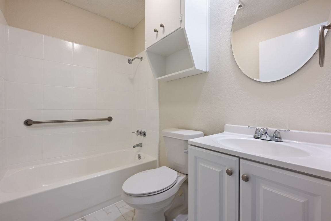 608 Country Aire Drive, Unit A Round Rock, TX 78664 - Photo 26 of 32 a bathroom with a sink toilet and shower
