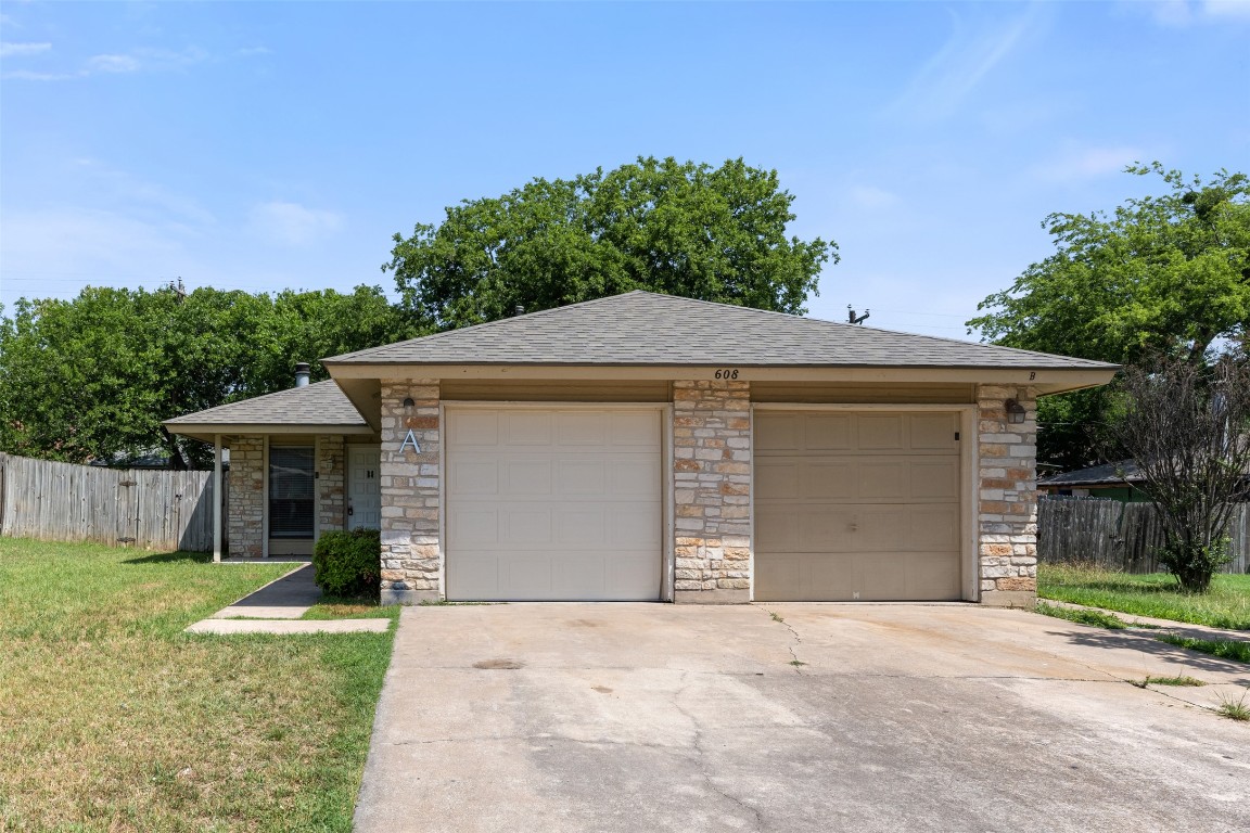 608 Country Aire Drive, Unit A Round Rock, TX 78664 - Photo 3 of 32 a front view of a house with a yard and garage