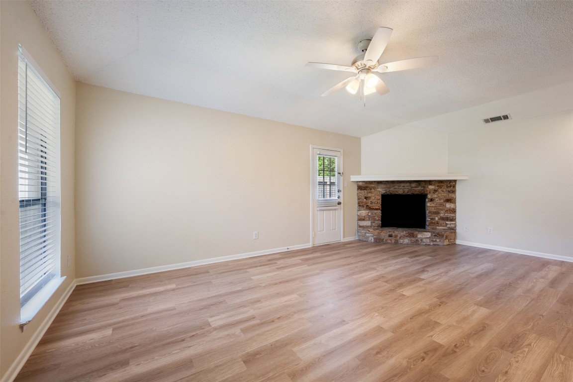 608 Country Aire Drive, Unit A Round Rock, TX 78664 - Photo 6 of 32 a view of an empty room with wooden floor and a window