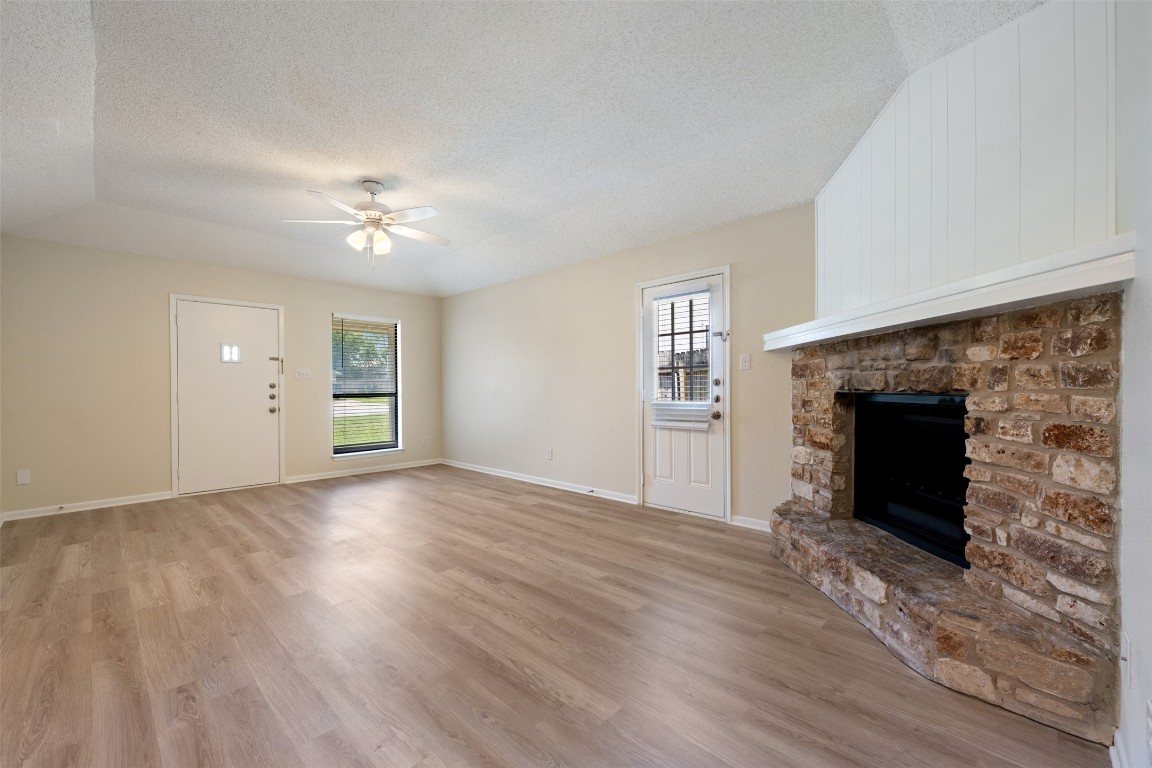 608 Country Aire Drive, Unit A Round Rock, TX 78664 - Photo 8 of 32 an empty room with windows and fireplace