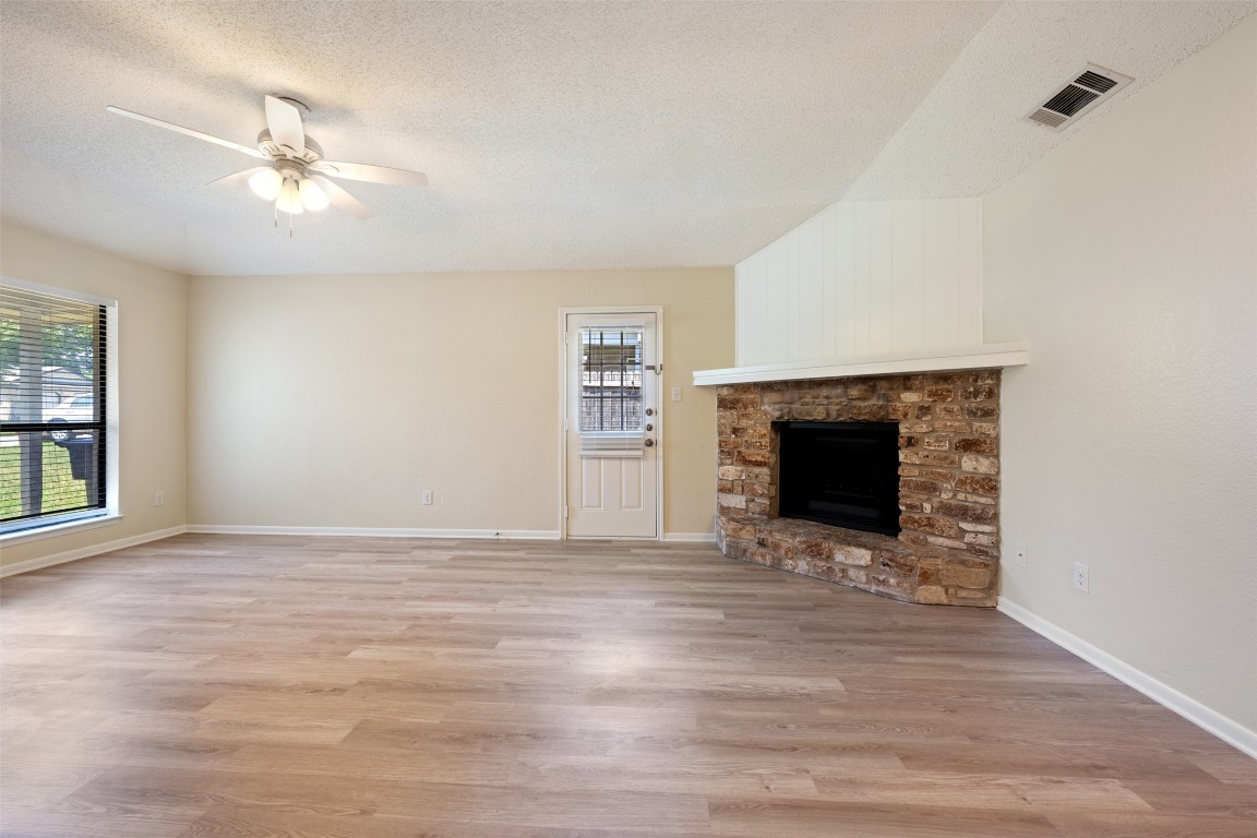 608 Country Aire Drive, Unit A Round Rock, TX 78664 - Photo 9 of 32 a view of an empty room with a fireplace and a window