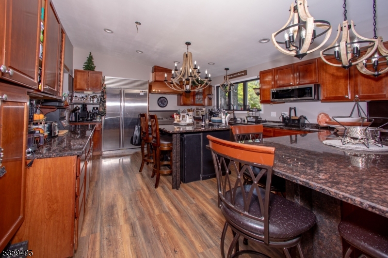 76 Glen Road Wantage, NJ 07461 - Photo 12 of 47 a view of a dining room with furniture a chandelier and wooden floor