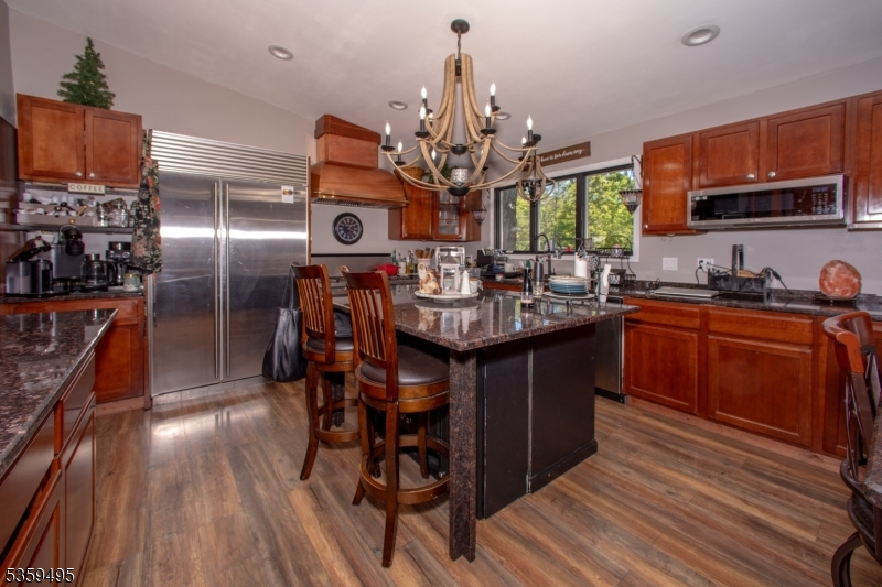 76 Glen Road Wantage, NJ 07461 - Photo 13 of 47 a kitchen with stainless steel appliances granite countertop a sink a stove and a wooden floors