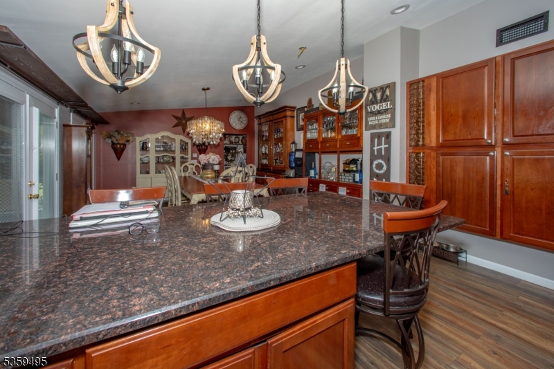 76 Glen Road Wantage, NJ 07461 - Photo 15 of 47 a view of a dining room with furniture a chandelier and wooden floor