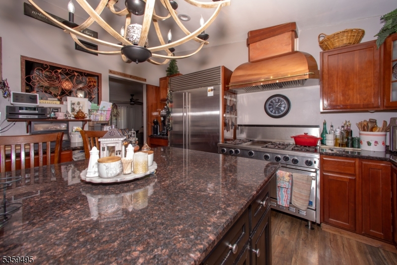 76 Glen Road Wantage, NJ 07461 - Photo 16 of 47 a kitchen with stainless steel appliances granite countertop a sink a stove and wooden floors