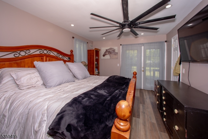 76 Glen Road Wantage, NJ 07461 - Photo 23 of 47 a bedroom with a bed and wooden floor