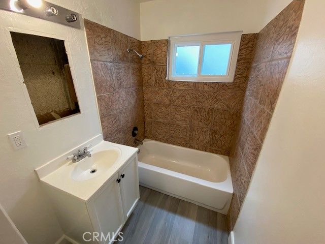 a bathroom with a sink a mirror and a bathtub