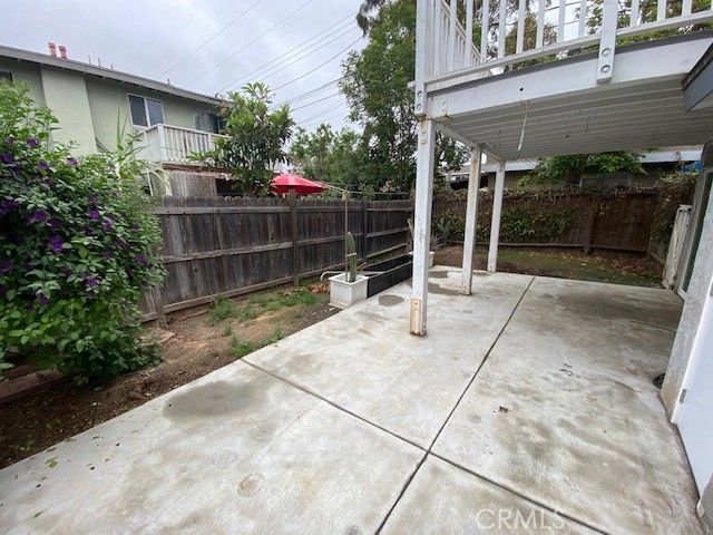 a backyard of a house with potted plants