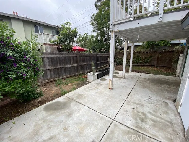 a backyard of a house with potted plants