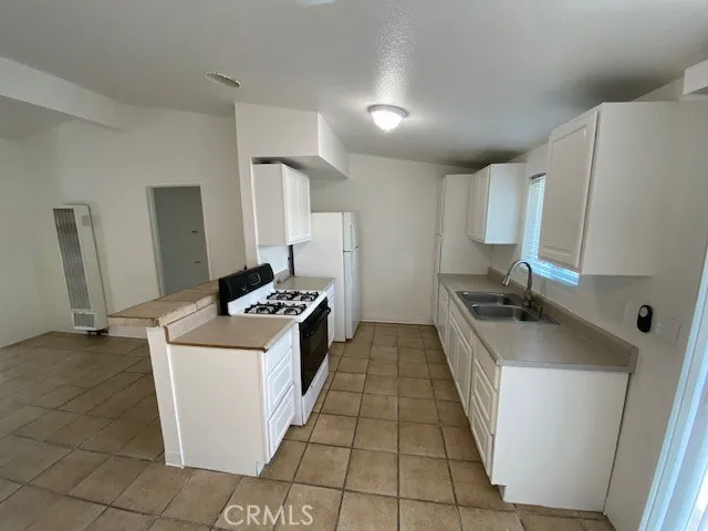a kitchen with sink a stove and refrigerator