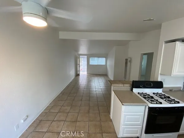 a kitchen with a stove a refrigerator and cabinets