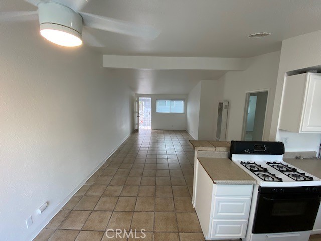 2214 Rutgers Drive Costa Mesa, CA 92627 - Photo 20 of 25 a kitchen with a stove a refrigerator and cabinets