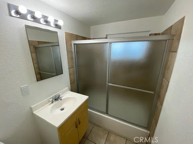 a bathroom with a sink a mirror and a shower