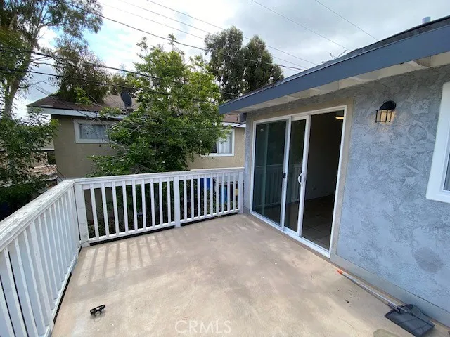 a view of backyard with large trees and wooden fence