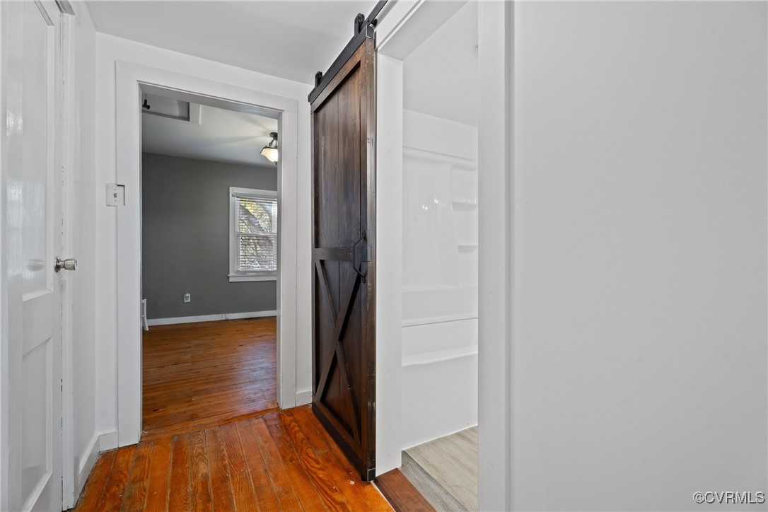 6405 King William Road Aylett, VA 23009 - Photo 17 of 40 Hall with a barn door and hardwood / wood-style fl