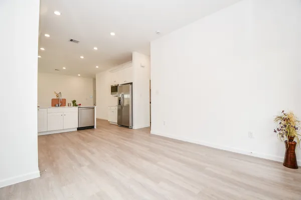 a view of a kitchen with a sink and a refrigerator