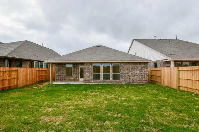 a view of a house with a yard and sitting area