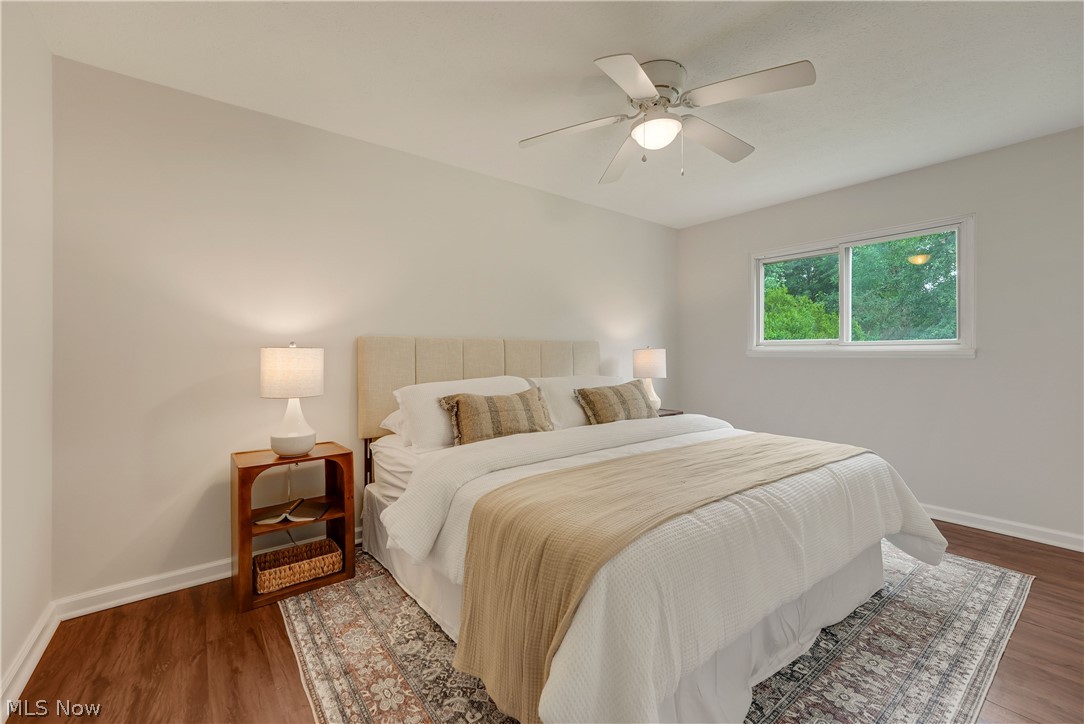 646 Ledge Road Macedonia, OH 44056 - Photo 12 of 28 Spacious bedroom featuring wood-finish flooring, a contemporary ceiling fan with integrated lighting, and a broad window