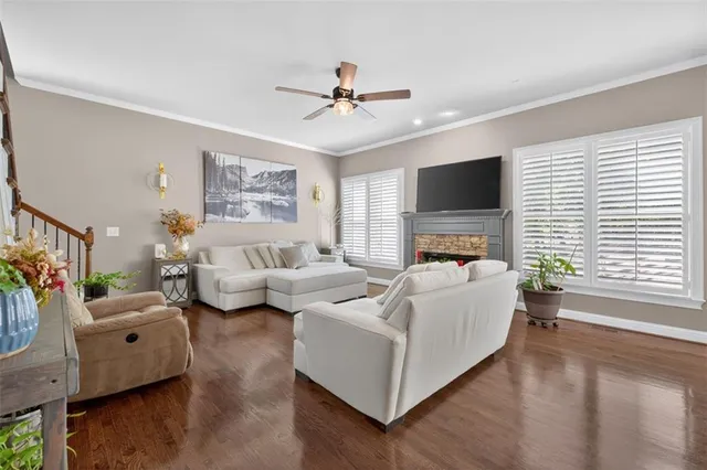 a kitchen with stainless steel appliances granite countertop a stove a sink dishwasher a dining table and chairs with wooden floor