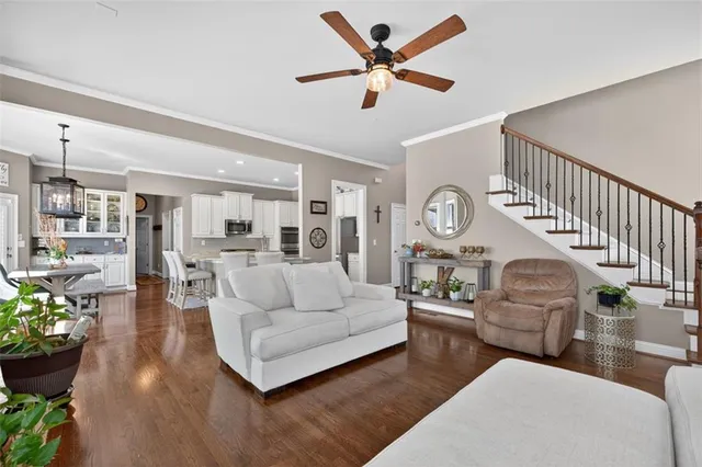 a living room with furniture and a potted plant
