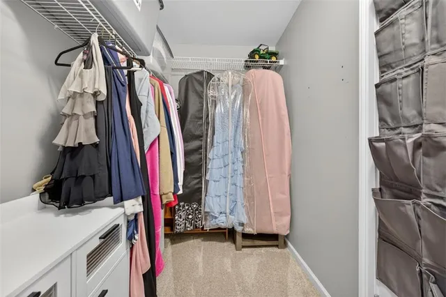a view of a yard in front of a brick house with large windows