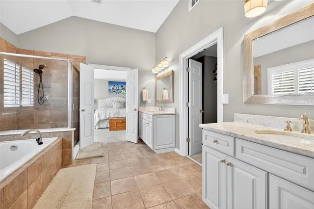 a front view of a house with a garden and tree