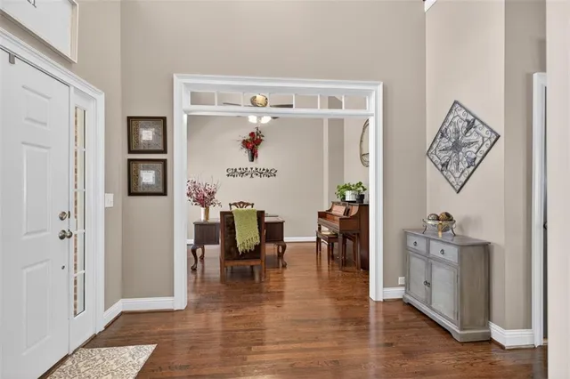 a living room with furniture large window and a flat screen tv