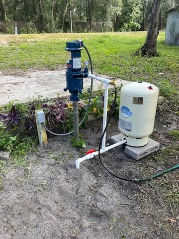 a bedroom with a bed and a refrigerator