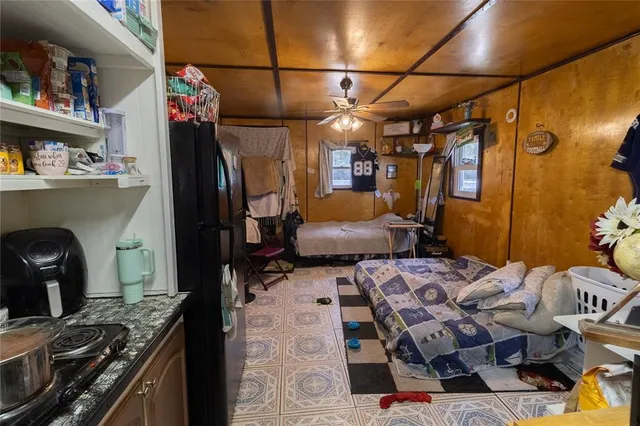 a kitchen with stainless steel appliances kitchen island granite countertop a refrigerator and a sink