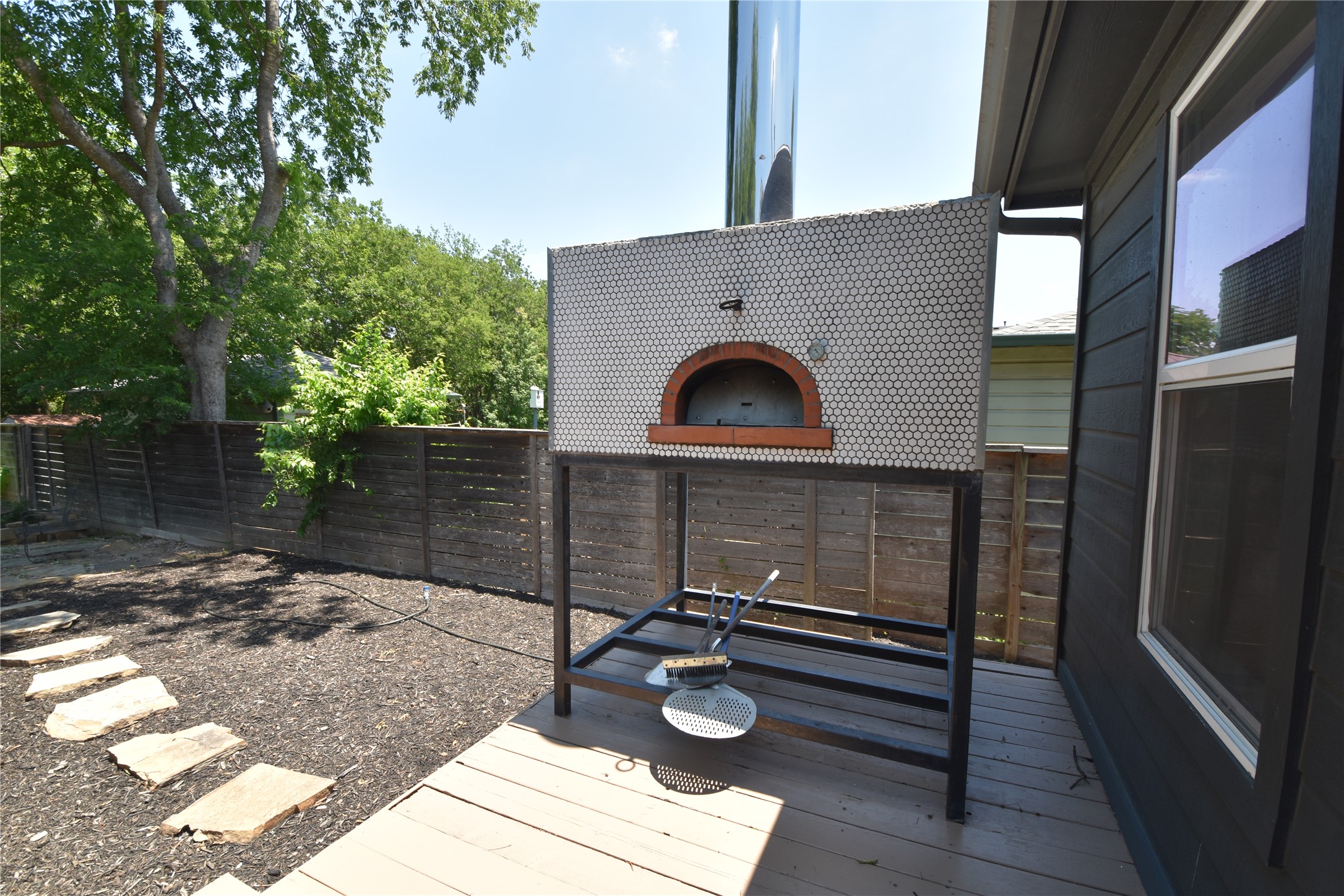 2012 Payne Avenue, Unit A Austin, TX 78757 - Photo 27 of 33 deck leading to backyard with a built in pizza oven for great entertaining