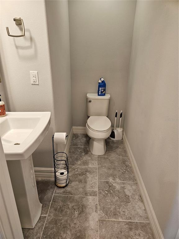 2812 Cello Lane Kissimmee, FL 34741 - Photo 12 of 34 a bathroom with a toilet and a sink