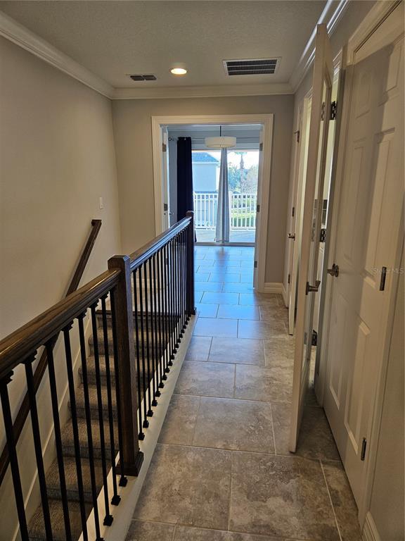 2812 Cello Lane Kissimmee, FL 34741 - Photo 13 of 34 a view of a hallway with wooden floor and staircase