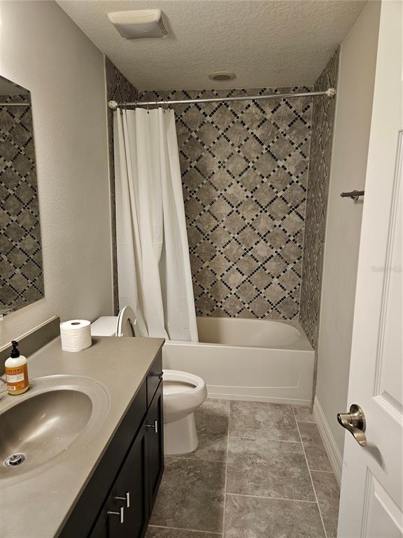 2812 Cello Lane Kissimmee, FL 34741 - Photo 17 of 34 a bathroom with a sink toilet and shower