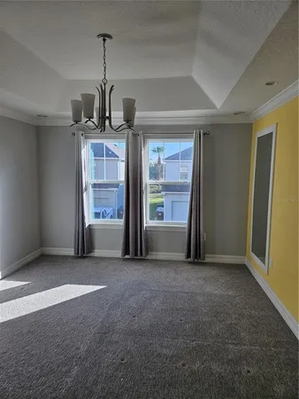 an empty room with a fireplace and cabinet