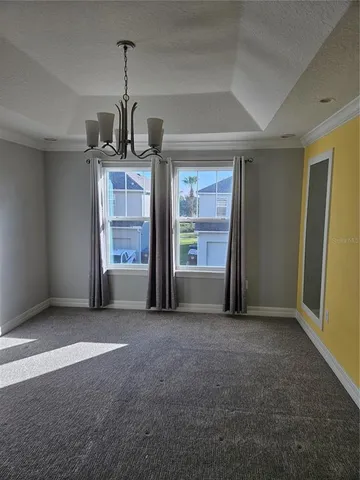 an empty room with a fireplace and cabinet