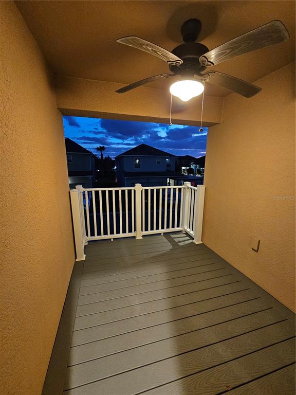 2812 Cello Lane Kissimmee, FL 34741 - Photo 30 of 34 a view of a balcony with a table and chairs